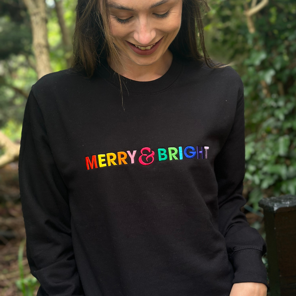 Merry Bright Rainbow Embroidered Christmas Sweatshirt in Black